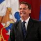 Brazil's President Jair Bolsonaro laughs during a joint press conference with Chilean President Sebastian Pinera (out frame) at La Moneda Presidential Palace in Santiago, on March 23, 2019.