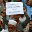 A supporter of the group Sunni Tehreek holds a placard during an anti-Indian protest in Karachi
