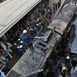 Firefighters and onlookers at the scene of a train crash in Cairo's main rail station last month