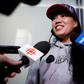 Vanessa Rodel smiles during a media scrum after arriving with her daughter Keana at Toronto airport on a flight from Hong Kong