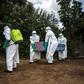 Health workers carry the coffin of an Ebola fatality in Mangina, North Kivu, last August