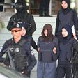 Vietnamese national Doan Thi Huong (brown headscarf) is escorted by Malaysian police after her last court appearance
