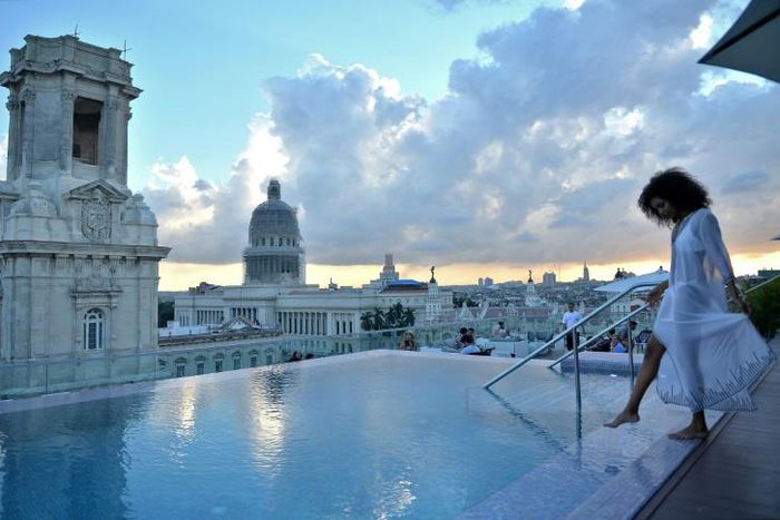 A tourist stands by the rooftop swimming pool at the Gran Hotel Manzana in Havana -- one of many luxury properties attracting tourists in Cuba