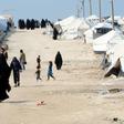 Foreign women and children walk inside the Al Hol camp housing relatives of Islamic State group members in northeastern Syria in March 2019