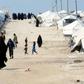 Foreign women and children walk inside the Al Hol camp housing relatives of Islamic State group members in northeastern Syria in March 2019