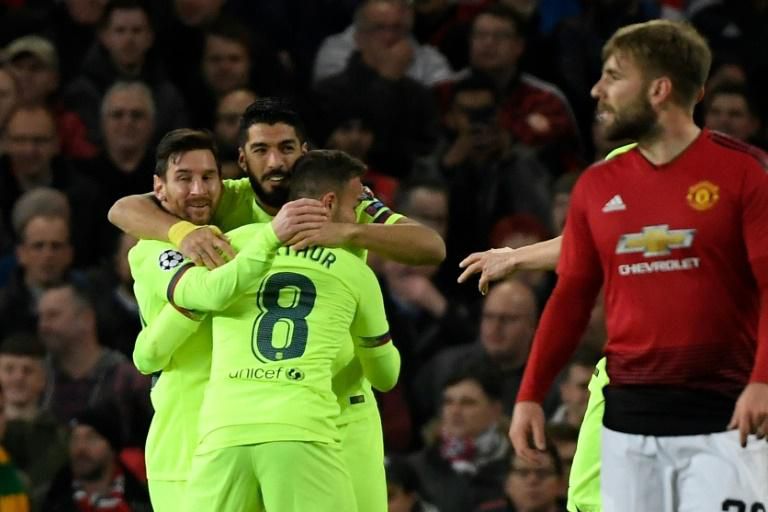 Luis Suarez (C) celebrates after his header was diverted home by United defender Luke Shaw