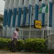 A man walk past a Western Union money transfer and Moneygram in Benin City, Nigeria