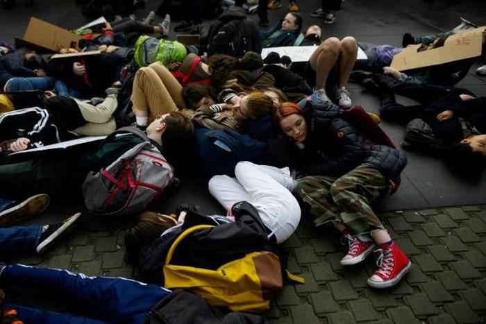 Students at the United Nations in New York stage a "die-in," lying sprawled on the pavement to protest the lethal consequences of global warming
