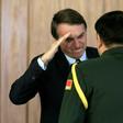 Brazilian President Jair Bolsonaro (L) salutes a Chinese military official as new diplomats presented their on Friday