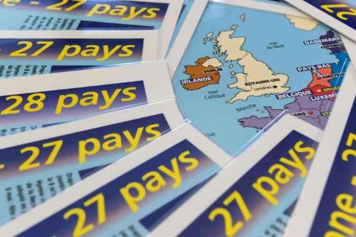 In a hangar that serves as the logistic hub of publisher AEDIS in central France, dozens of copies of laminated leaflets on 'Europe at 27' rest on boxes