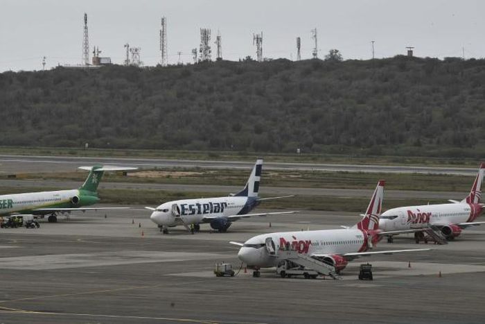 Commercial planes sit on the tarmac at Simon Bolivar International Airport in Maiquetia, in the state of Vargas, northern Venezuela, on March 8, 2019 during the worst power outage in the country's history