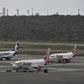 Commercial planes sit on the tarmac at Simon Bolivar International Airport in Maiquetia, in the state of Vargas, northern Venezuela, on March 8, 2019 during the worst power outage in the country's history