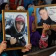 Families of victims of Tunisia's 2011 revolt against dictatorship carry portraits of their loved ones during a trial in Kasserine on July 13, 2018