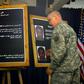 A US solider shows a picture of Ali Mussa Daqduq during a July 2007 press conference in Baghdad