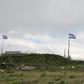Israeli flags fly over a military base near the border fence with Syria in the Israeli-annexed Golan Heights, south of the Druze village of Majdal Shams