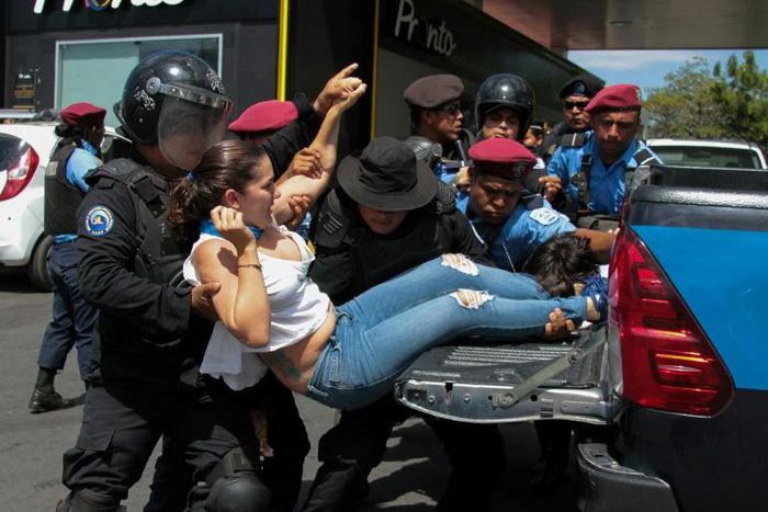 Riot police square off with anti-government demonstrators in Nicaragua, now on a new human rights black list