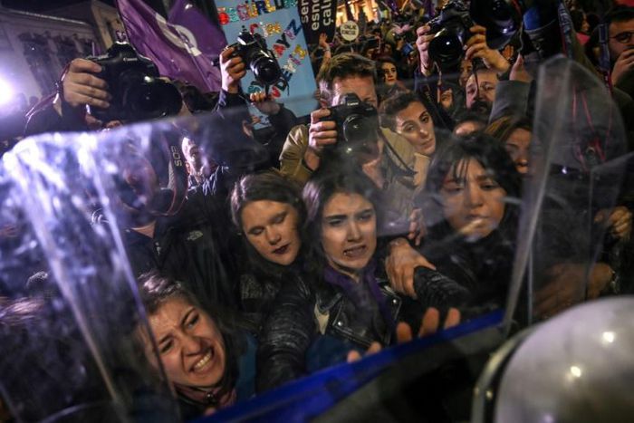 Security forces in riot gear pushed the crowds of women -- some wearing colourful wigs and masks -- at the entrance to the city's main pedestrianised shopping street