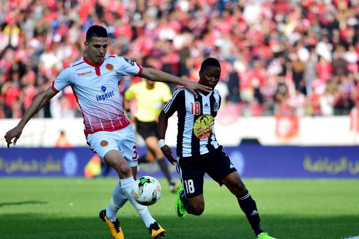 Mohamed Nahiri (L) of Wydad Casablanca shields the ball from Rainford Kalaba of TP Mazembe. Both clubs will be in CAF Champions League quarter-finals action Saturday. 