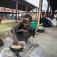 Homeless: Children cook corn at a camp for displaced people in Bangula, southern Malawi