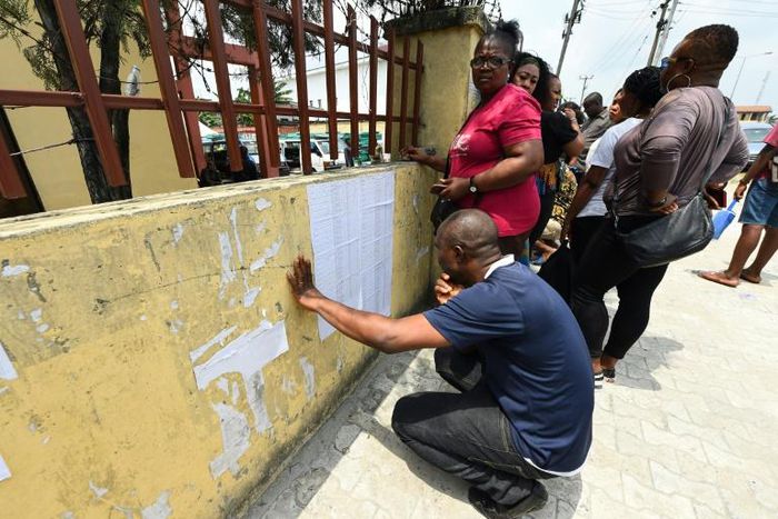 People check their names on a voters' list