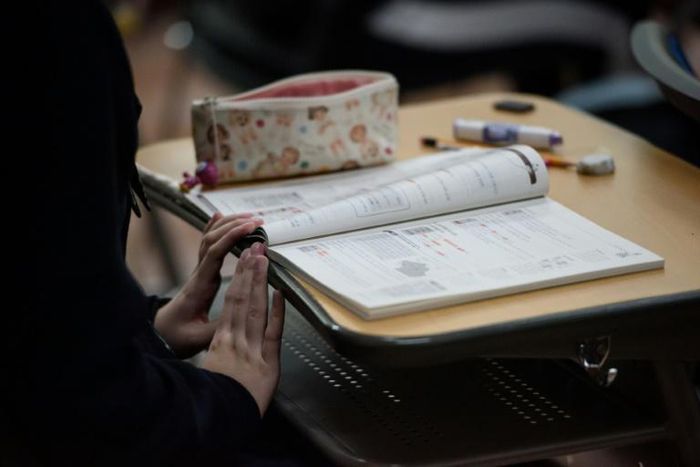 A student prepares to sit for college entrance exams in Seoul last year. South Korea's hyper-competitive education system frequently leads parents into breaking the rules to give their children an advantage