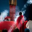 Father Celso Taibo burns incense during a palm Sunday mass in Buzi