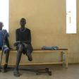 Gunshot wound survivors Jal Keat, 12, left, and Nyagn Thyuong, wait at the Red Cross rehabilitation centre in Juba