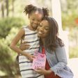 Happy Mother's Day Girl gives card to mother