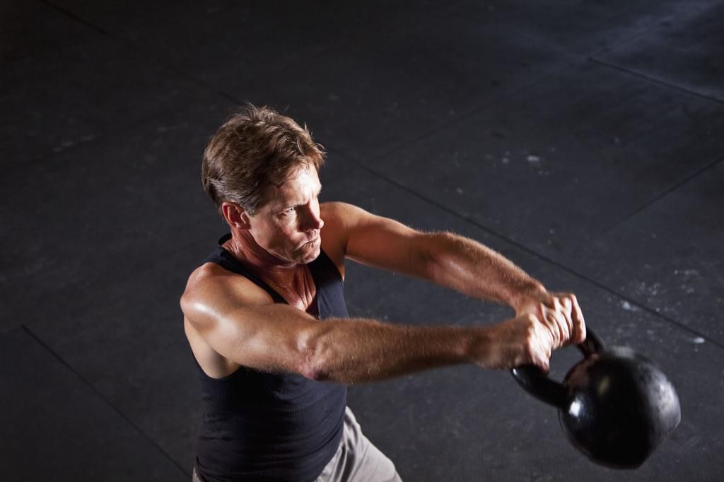 Man working out with kettle bell