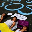 Opponents to the government of Venezuelan President Nicolas Maduro with a Venezuelan national flag block a street as they demonstrate in Caracas on March 12, 2019