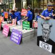 Protesters hold placards outside the court ahead of the sentencing of Cardinal George Pell in Melbourne on Wednesday