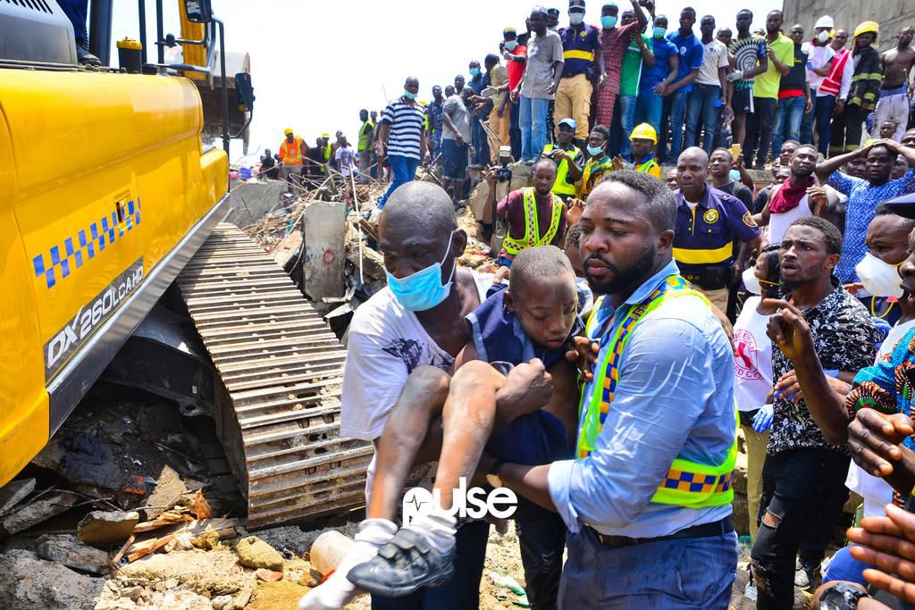 Two men carrying an unconscious child to be treated (Pulse)