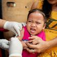 A child reacts during a Philippine Read Cross Measles Outbreak Vaccination Response in Manila on February 16, 2019