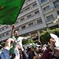 Algerians wave the national flag during a protest rally against ailing President Bouteflika's bid for a fifth term, in the capital Algiers on March 1, 2019