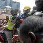 Survivor: Emergency workers pluck a child from the collapsed building. The disaster left 20 dead, according to a new toll