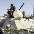 Sudanese protesters salute soldiers in front of the military headquarters in the capital Khartoum