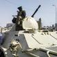 Sudanese protesters salute soldiers in front of the military headquarters in the capital Khartoum