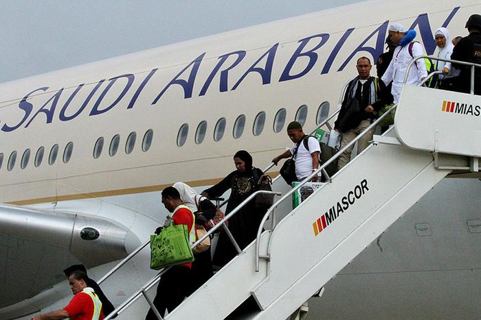 This photo provided by the Manila International Airport Authority Media Affairs Division, passengers of the Saudi Arabian Airlines plane Flight SV872 from Jiddah disembark at Manila's International Airport in Pasay, south of Manila, Philippines on Tues...