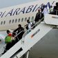 This photo provided by the Manila International Airport Authority Media Affairs Division, passengers of the Saudi Arabian Airlines plane Flight SV872 from Jiddah disembark at Manila's International Airport in Pasay, south of Manila, Philippines on Tues...