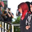 Vietnamese national, Doan Thi Huong (2nd R)is escorted by Malaysian police at the Shah Alam High Court, outside Kuala Lumpur, on March 14, 2019 to stand trial for her alleged role in the assassination of Kim Jong Nam
