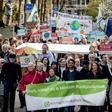 Dozens of activists march toward Shell's base in The Hague, where they will deliver a legal summons with a court date set for April 17, 2019