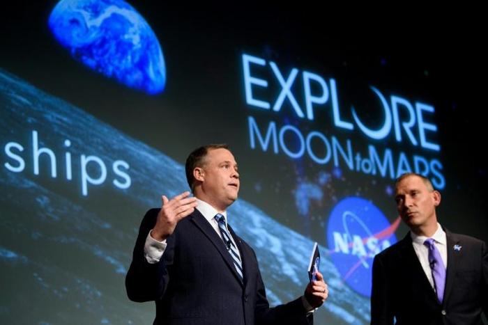NASA Administrator Jim Bridenstine (L) -- seen here at the US space agency's headquarters in November 2018 -- says the acceleration of the calendar for a new Moon mission is "aggressive" but doable, and vital for any future Mars mission