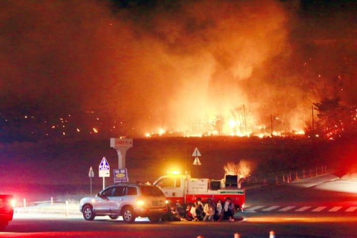 Fanned by strong winds the fire quickly spread through the mountainous area close to the border with North Korea, incinerating 400 homes and 500 hectares of land