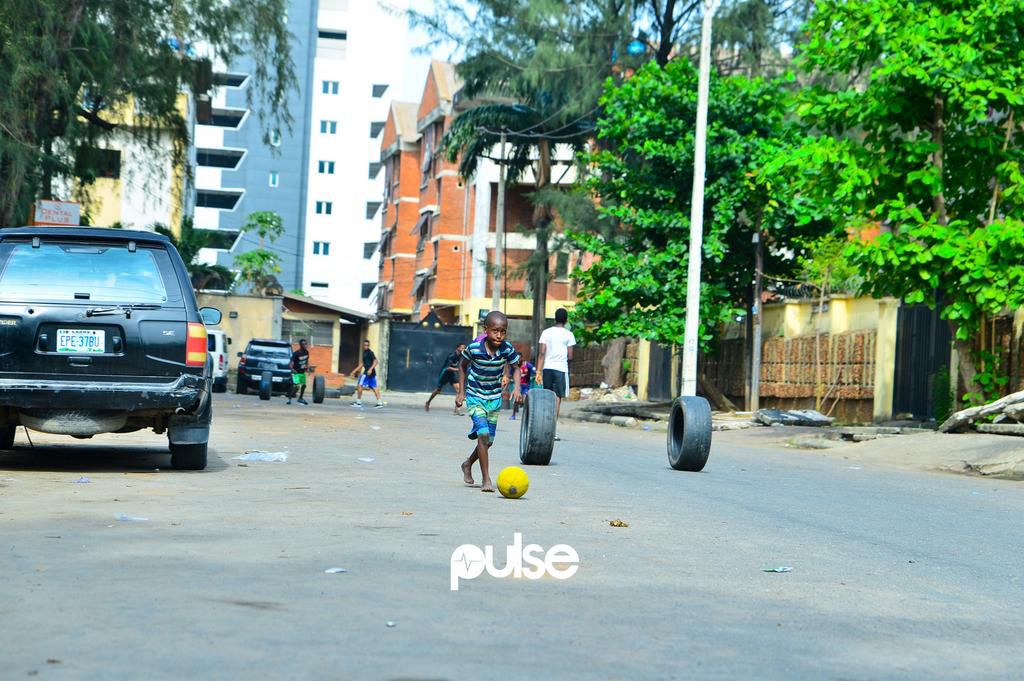 A young boy runs after a ball in Victoria Island (Pulse)