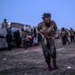 Suspected members of the Islamic State group are among thousands leaving the jihadists' last Syrian stronghold