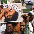 Indian Muslims hold a photo of Jaish-e-Mohammad leader Masood Azhar during a protest in Mumbai after an attack on Indian police in Kashmir