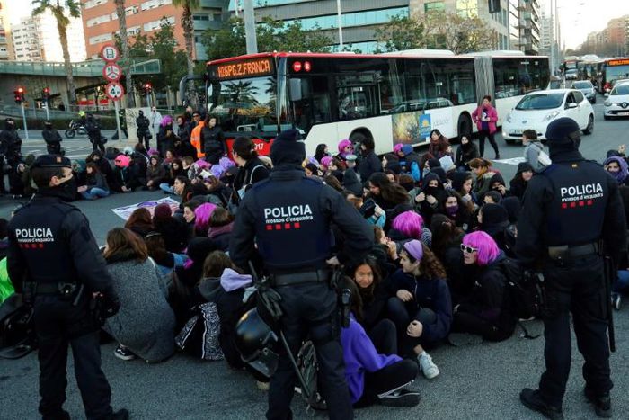Demonstrators in Barcelona blocked a major thoroughfare, some wearing purple wigs -- the colour long associated with gender equality