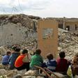 Children watch a puppet show in the ruins of the town of Saraqib in Syria's jihadist-held Idlib region where renewed fighting threatens to flare