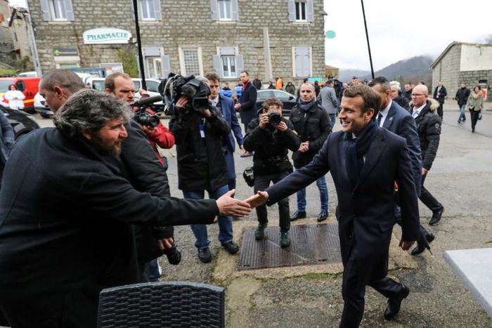 French President Emmanuel Macron, right, in the Corsican village of Cozzano on Thursday before the last public meeting of his "great national debate"