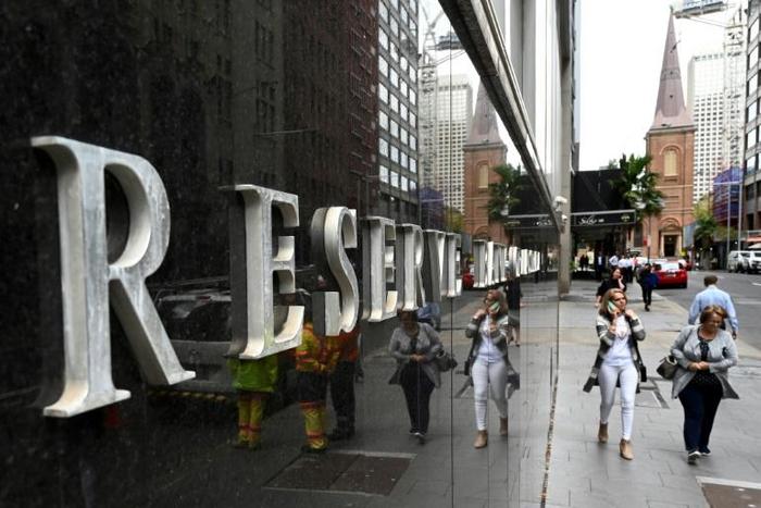 Pedestrians reflected in the wall of the Reserve Bank of Australia on Tuesday after the government unveiled a big-spending federal budget